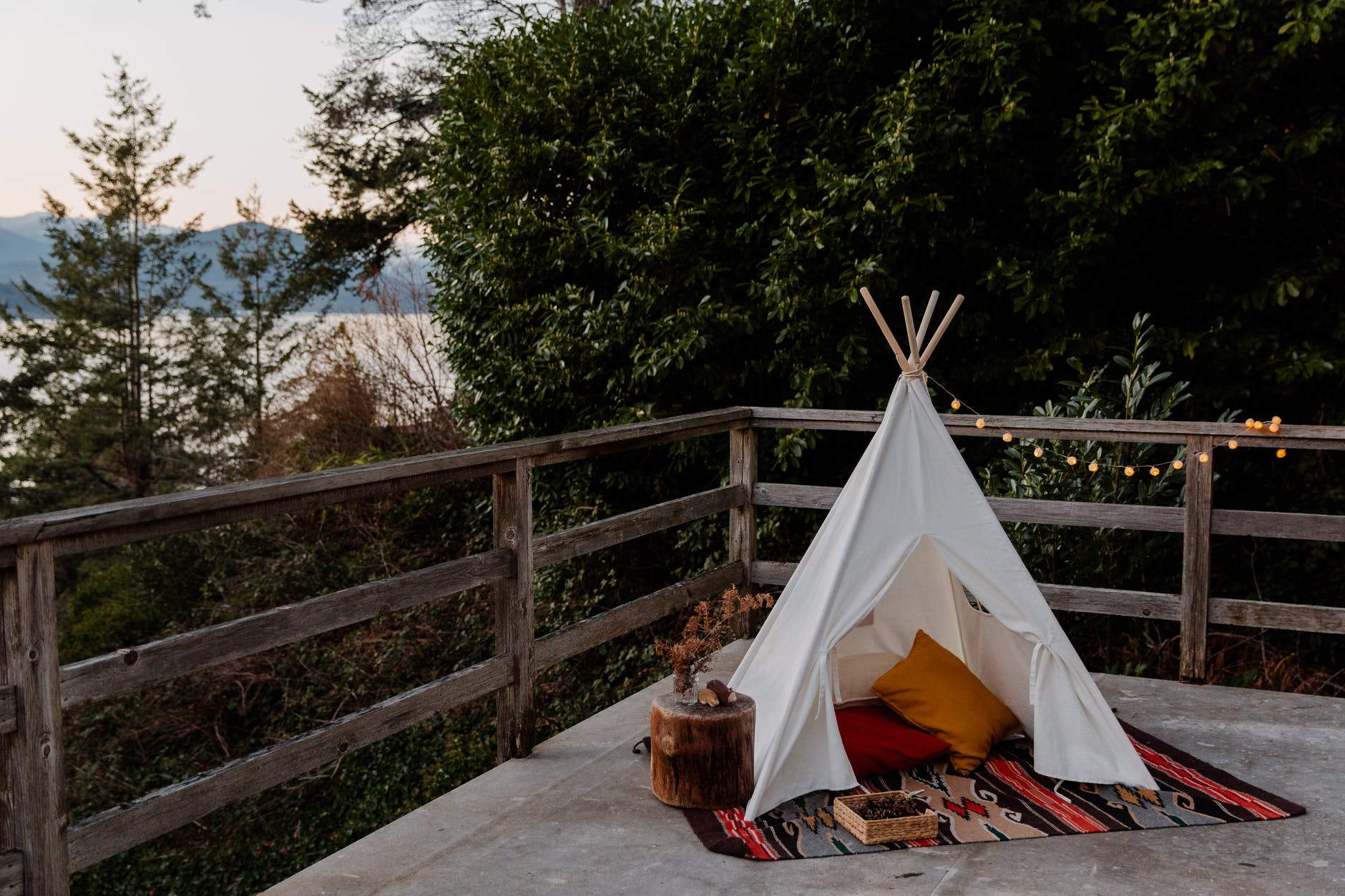 wigwam placed on wooden terrace with picturesque view